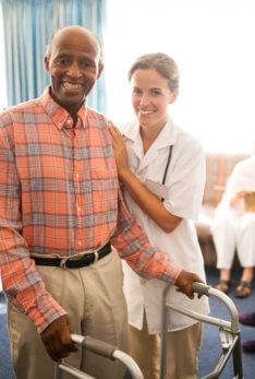 senior man and nurse smiling
