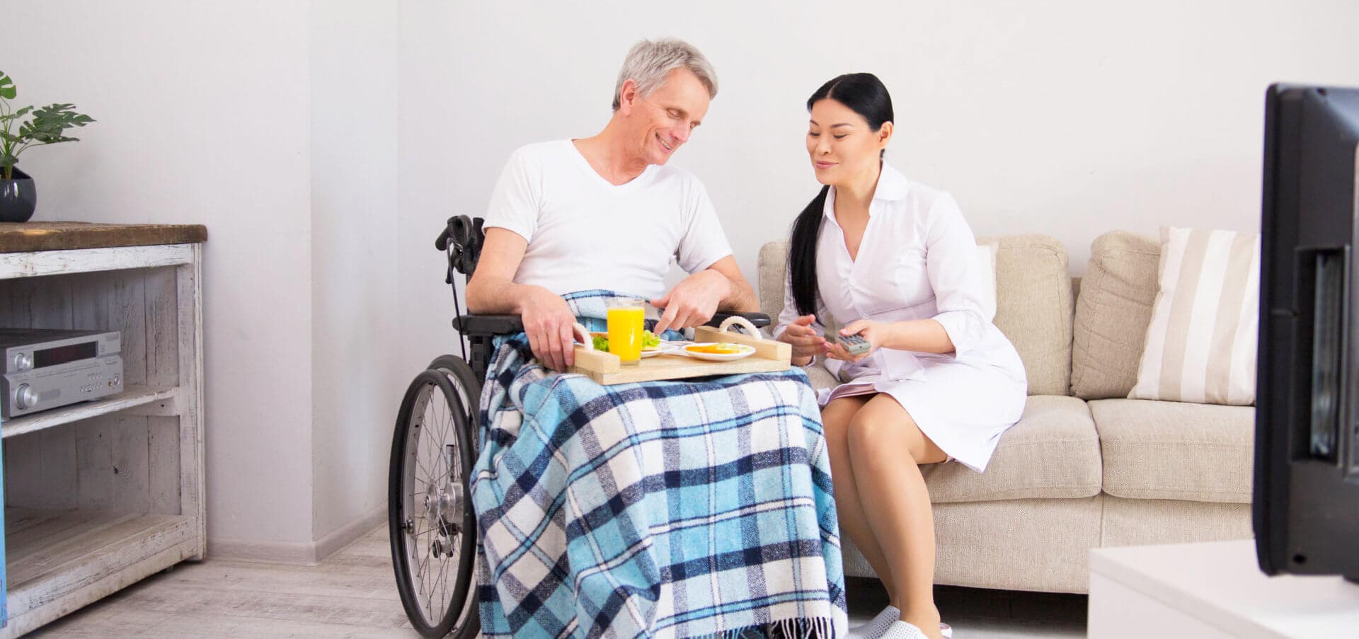caregiver giving meal to senior man