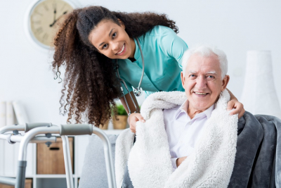 nurse and senior man smiling