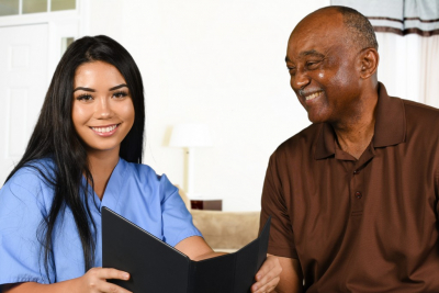 nurse and senior man smiling