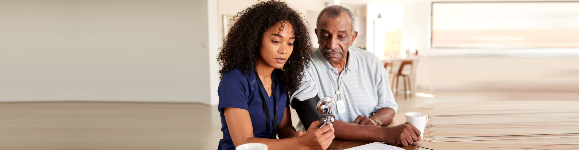nurse checking senior man's blood pressure
